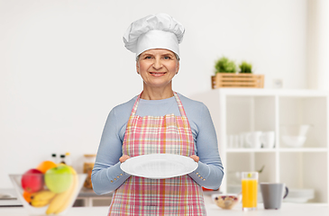 Image showing smiling senior woman or chef holding empty plate