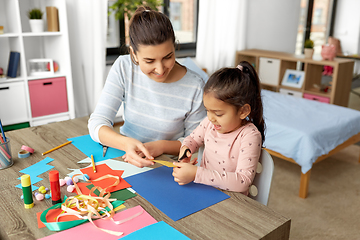 Image showing daughter with mother making applique at home