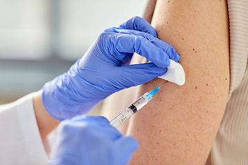 Image showing close up of hand with syringe vaccinating patient