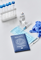 Image showing immunity passport, mask, syringe, vaccine on table