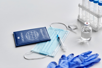 Image showing immunity passport, mask, syringe, vaccine on table