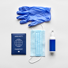 Image showing immunity passport, mask, gloves and hand sanitizer