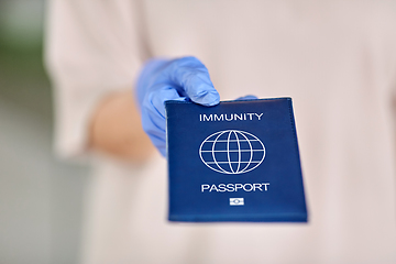 Image showing woman in glove holding immunity passport