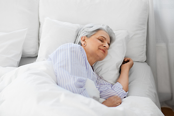 Image showing senior woman sleeping in bed at home bedroom