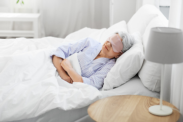 Image showing senior woman with eye mask sleeping in bed at home