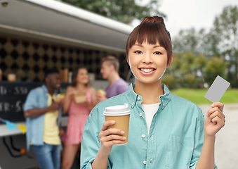 Image showing happy asian woman drinking coffee over food truck