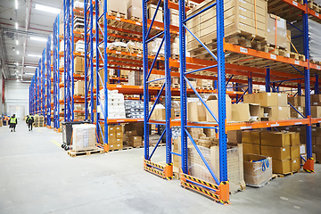 Image showing Huge distribution warehouse with high shelves and loaders.