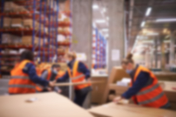 Image showing Blur warehouse background. Warehouse worker taking package in the shelf in a large warehouse in a large warehouse