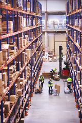 Image showing Blur warehouse background. Warehouse worker taking package in the shelf in a large warehouse in a large warehouse