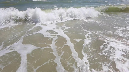 Image showing Powerful ocean waves crashing on a coast. Extreme stormy ocean waves splashing on a Beach