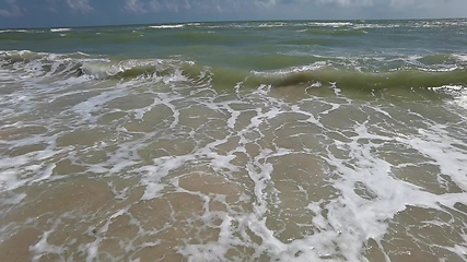 Image showing Powerful ocean waves crashing on a coast. Extreme stormy ocean waves splashing on a Beach