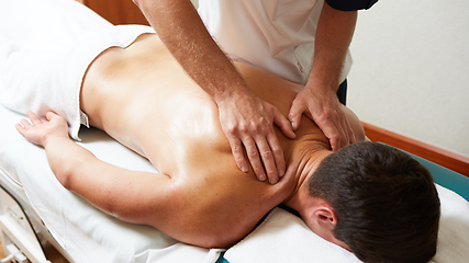 Image showing a massage therapist makes a man massage spa treatment health