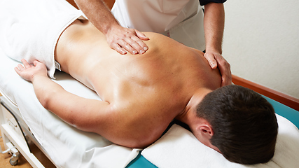 Image showing a massage therapist makes a man massage spa treatment health