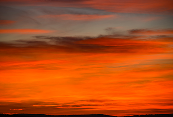 Image showing colorful red and orange clouds in the sky right after sunset