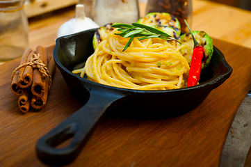 Image showing italian spaghetti pasta with zucchini sauce on iron skillet