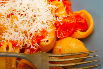 Image showing Italian snail lumaconi pasta with tomatoes