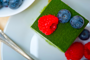 Image showing green tea matcha mousse cake with berries