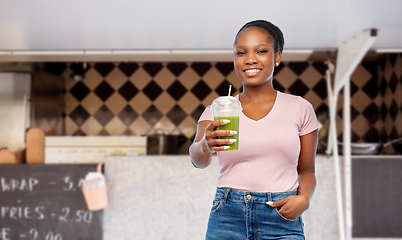 Image showing african american woman with juice over food truck