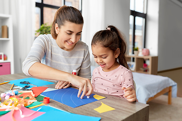 Image showing daughter with mother making applique at home