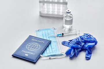 Image showing immunity passport, mask, syringe, vaccine on table