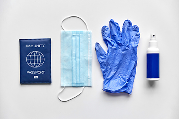 Image showing immunity passport, mask, gloves and hand sanitizer