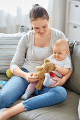 Image showing mother with baby playing with teddy bear at home