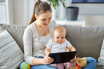 Image showing happy mother and baby girl with tablet pc at home