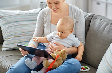 Image showing happy mother and baby girl with tablet pc at home