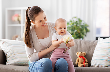 Image showing happy smiling mother with little baby at home