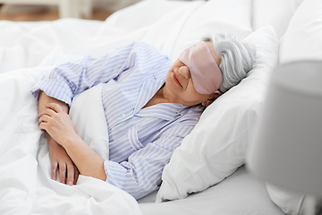 Image showing senior woman with eye mask sleeping in bed at home