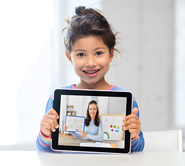 Image showing little girl with teacher on tablet pc at home