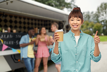 Image showing asian woman with coffee cup showing thumbs up