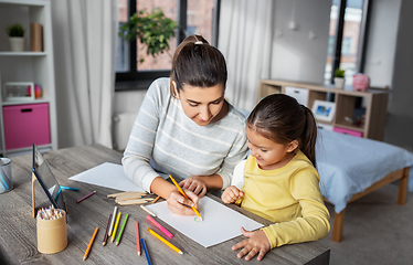 Image showing mother with little daughter drawing at home