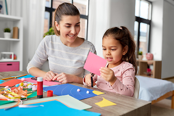 Image showing daughter with mother making applique at home