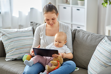 Image showing happy mother and baby girl with tablet pc at home