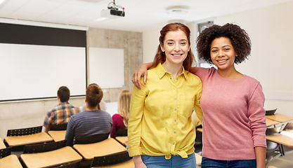 Image showing happy smiling student women hugging at university