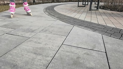 Image showing Little girl in roller skates at a park