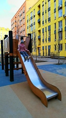 Image showing Girl having fun, playing in the slider at the playground.