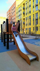 Image showing Girl having fun, playing in the slider at the playground.