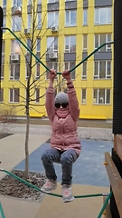 Image showing girl plays on the rope park playground. The concept of children's rest in an urban environment.