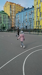 Image showing Mother and daughter ride on a scooter in the city