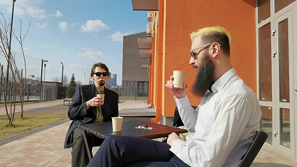 Image showing Two colleagues on coffee break in front of business building