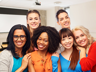 Image showing group of happy student women hugging at university