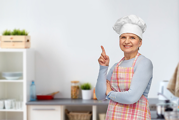Image showing senior woman or chef pointing finger up at kitchen