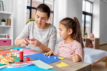 Image showing daughter with mother making applique at home