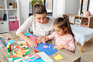 Image showing daughter with mother making applique at home