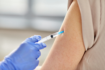 Image showing close up of hand with syringe vaccinating patient