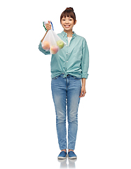 Image showing happy woman with apples in reusable net bag