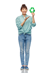 Image showing smiling asian woman holding green recycling sign