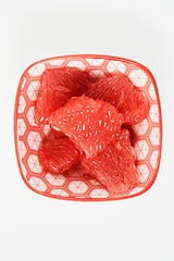 Image showing juicy red grapefruit slices on a small plate